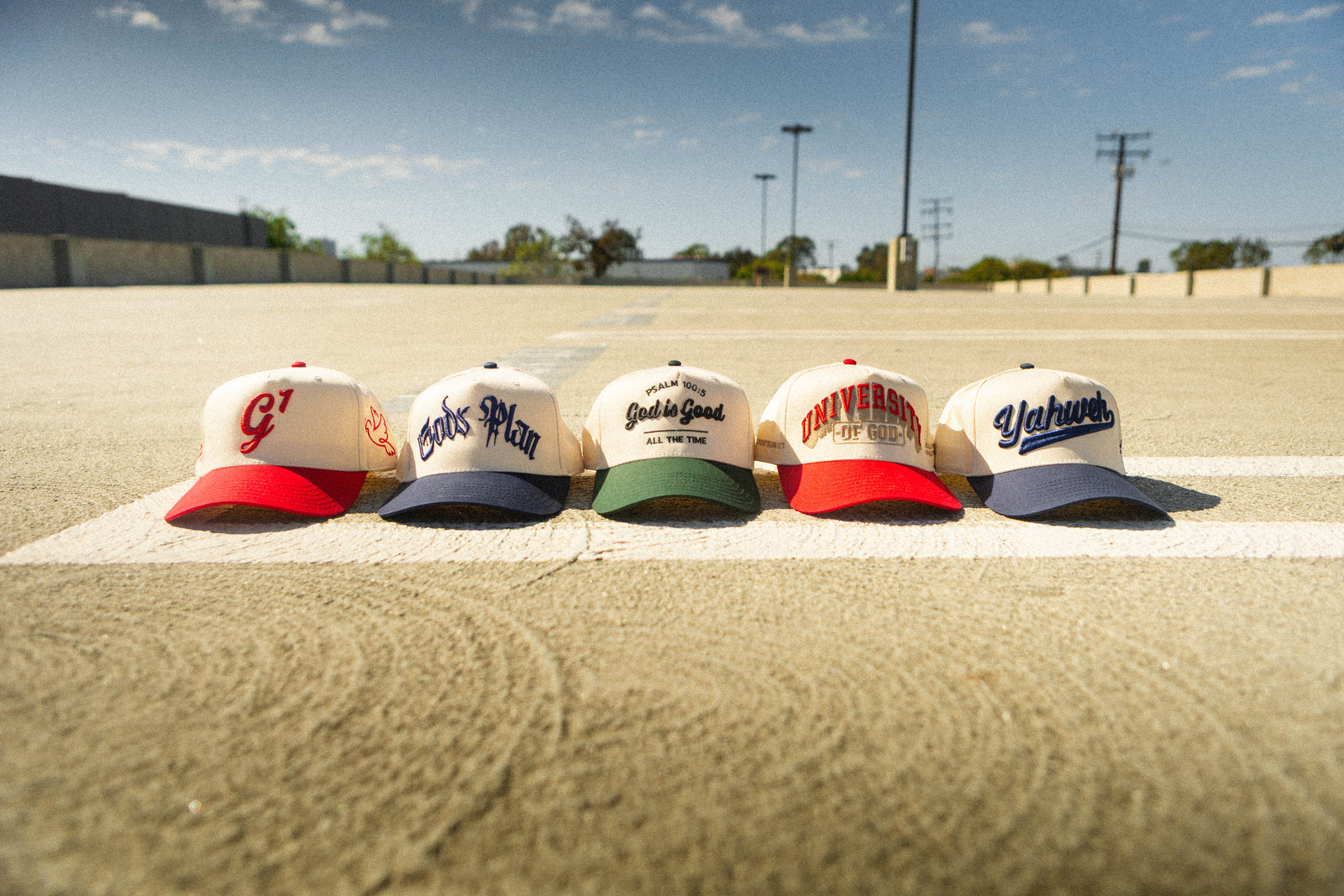 A row of Anchored Collection caps on asphalt